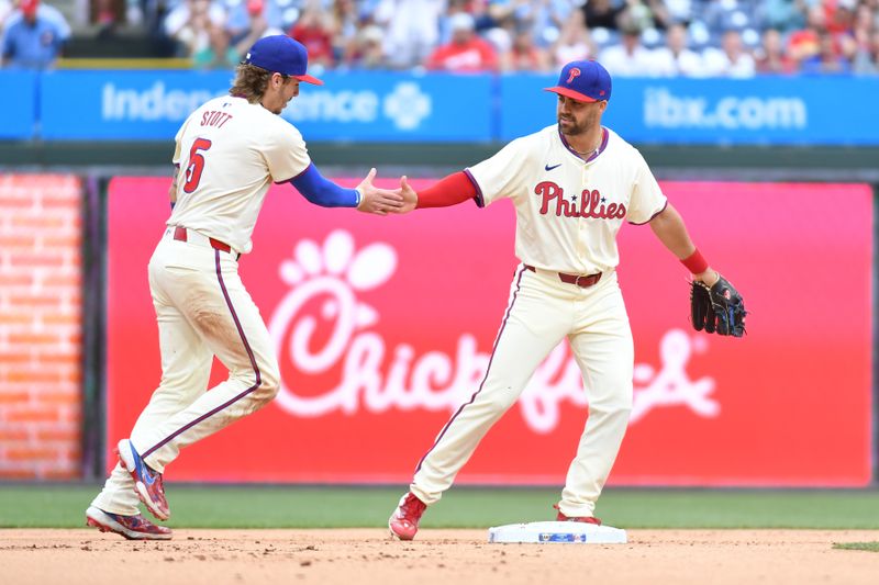 May 6, 2024; Philadelphia, Pennsylvania, USA; Philadelphia Phillies second base Bryson Stott (5) and outfielder Whit Merrifield (9) after a double play during the first inning against the San Francisco Giants at Citizens Bank Park. Mandatory Credit: Eric Hartline-USA TODAY Sports