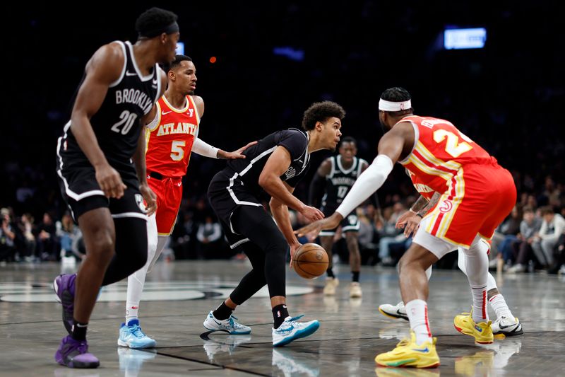 NEW YORK, NEW YORK - MARCH 02: Cameron Johnson #2 of the Brooklyn Nets dribbles as Dejounte Murray #5 and Bruno Fernando #24 of the Atlanta Hawks defend during the first half at Barclays Center on March 02, 2024 in the Brooklyn borough of New York City. NOTE TO USER: User expressly acknowledges and agrees that, by downloading and or using this photograph, User is consenting to the terms and conditions of the Getty Images License Agreement. (Photo by Sarah Stier/Getty Images)