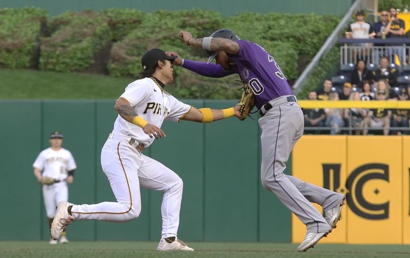May 9, 2023; Pittsburgh, Pennsylvania, USA; Pittsburgh Pirates second baseman Ji Hwan Bae (3) tags out Colorado Rockies center fielder Harold Castro (30) on a fielders choice during the fourth inning at PNC Park. Mandatory Credit: Charles LeClaire-USA TODAY Sports