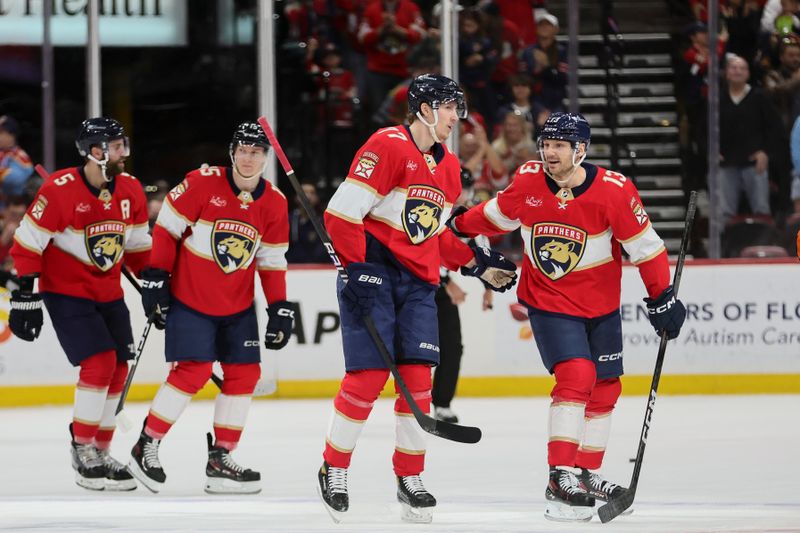 Jan 15, 2024; Sunrise, Florida, USA; Florida Panthers center Sam Reinhart (13) celebrates with center Evan Rodrigues (17) after scoring against the Anaheim Ducks during the first period at Amerant Bank Arena. Mandatory Credit: Sam Navarro-USA TODAY Sports