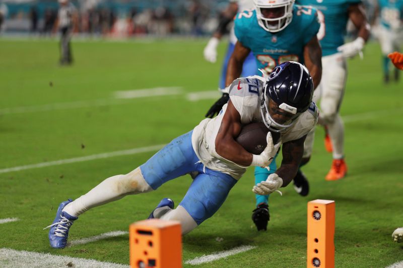 Tennessee Titans running back Tony Pollard (20) scores a touchdown during the second half of an NFL football game against the Miami Dolphins, Monday, Sept. 30, 2024, in Miami Gardens, Fla. (AP Photo/Brennan Asplen)