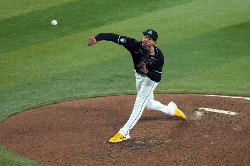 Jun 16, 2024; Phoenix, Arizona, USA; Arizona Diamondbacks pitcher Justin Martinez (63) pitches against the Chicago White Sox during the seventh inning at Chase Field. Mandatory Credit: Joe Camporeale-USA TODAY Sports