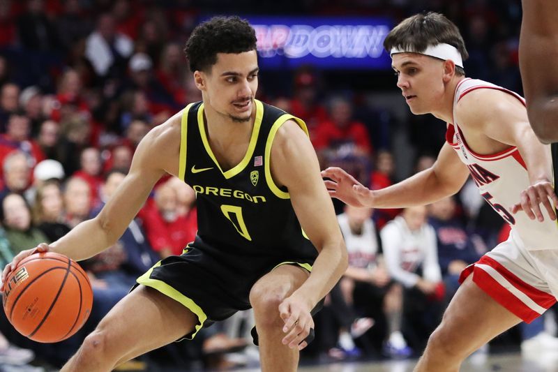 Feb 2, 2023; Tucson, Arizona, USA;Oregon Ducks guard Will Richardson (0) drives to the net against Arizona Wildcats guard Kerr Kriisa (25) in the first half at McKale Center. Mandatory Credit: Zachary BonDurant-USA TODAY Sports