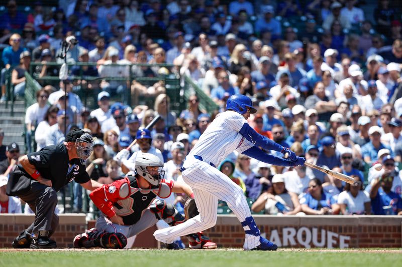 Jun 2, 2024; Chicago, Illinois, USA; Chicago Cubs outfielder Cody Bellinger (24) singles against the Cincinnati Reds during the first inning at Wrigley Field. Mandatory Credit: Kamil Krzaczynski-USA TODAY Sports