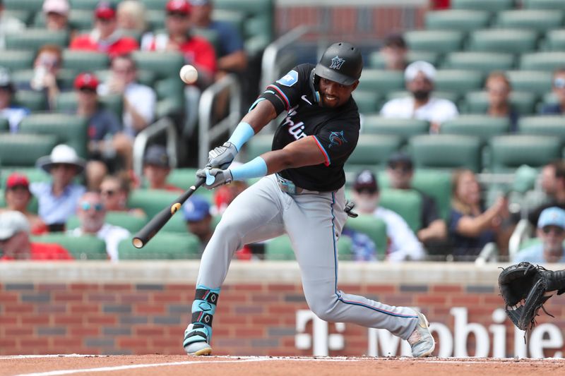 Aug 4, 2024; Cumberland, Georgia, USA; Miami Marlins right fielder Jesus Sanchez (12) hits a fly ball against Atlanta Braves in the first inning at Truist Park. Mandatory Credit: Mady Mertens-USA TODAY Sports