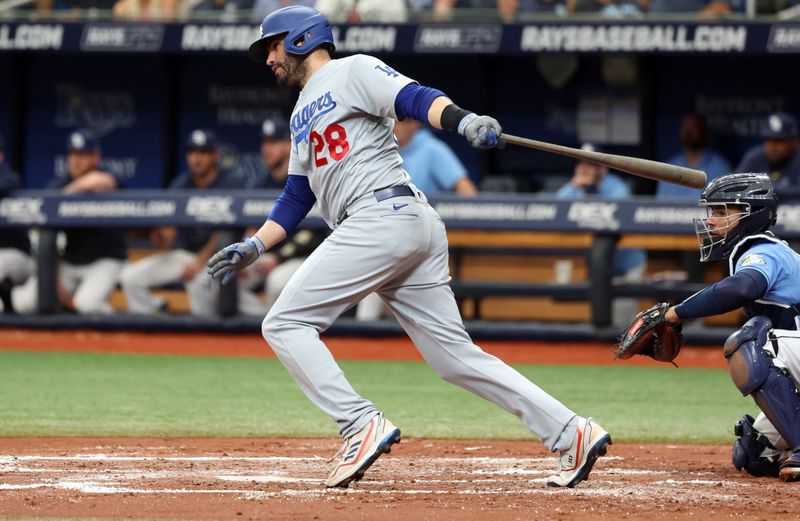 May 28, 2023; St. Petersburg, Florida, USA;Los Angeles Dodgers designated hitter J.D. Martinez (28) hits an RBI double against the Tampa Bay Rays during the third inning  at Tropicana Field. Mandatory Credit: Kim Klement-USA TODAY Sports