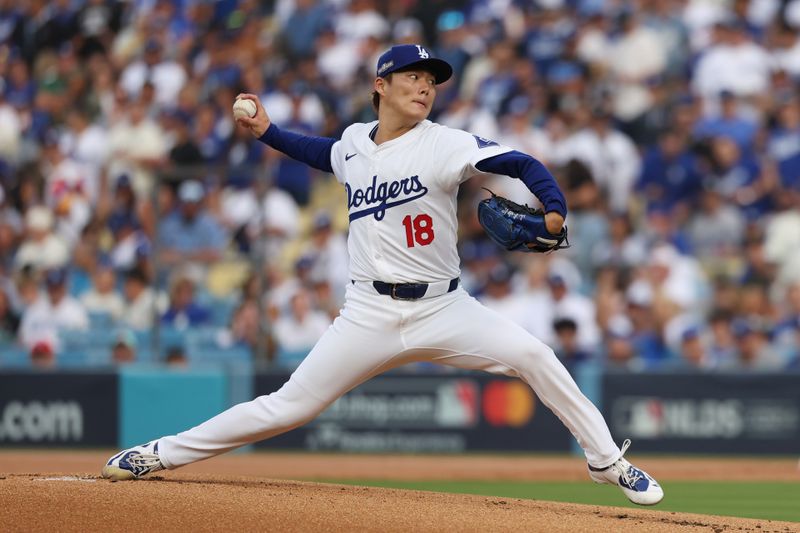 Oct 11, 2024; Los Angeles, California, USA; Los Angeles Dodgers pitcher Yoshinobu Yamamoto (18) pitches against the San Diego Padres in the first inning during game five of the NLDS for the 2024 MLB Playoffs at Dodger Stadium. Mandatory Credit: Kiyoshi Mio-Imagn Images