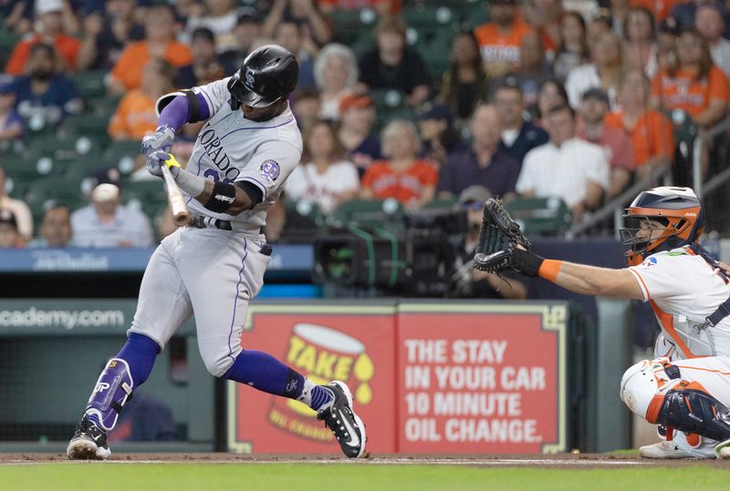 Jul 5, 2023; Houston, Texas, USA; Colorado Rockies left fielder Jurickson Profar (29) hits a single against the Houston Astros in the first inning at Minute Maid Park. Mandatory Credit: Thomas Shea-USA TODAY Sports
