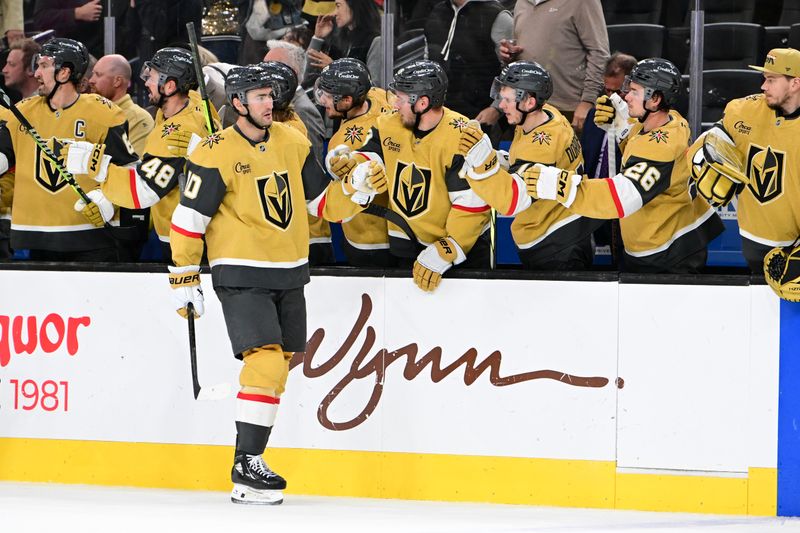 Oct 28, 2024; Las Vegas, Nevada, USA; Vegas Golden Knights center Nicolas Roy (10) celebrates his third-period goal with teammates against the Calgary Flames at T-Mobile Arena. Mandatory Credit: Candice Ward-Imagn Images