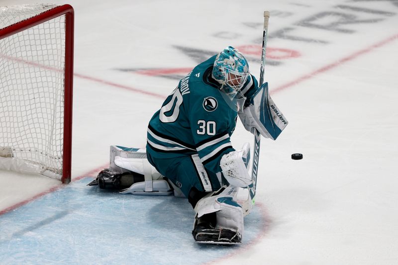 Nov 1, 2025; San Jose, California, USA; San Jose Sharks goaltender Yaroslav Askarov (30) makes a save against the Colorado Avalanche during the third period at SAP Center at San Jose. Mandatory Credit: Dennis Lee-Imagn Images