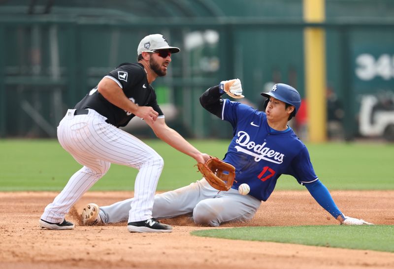 Mar 6, 2024; Phoenix, Arizona, USA; Los Angeles Dodgers designated hitter Shohei Ohtani (17) steals second base against Chicago White Sox infielder Paul DeJong during a spring training baseball game at Camelback Ranch-Glendale. Mandatory Credit: Mark J. Rebilas-USA TODAY Sports