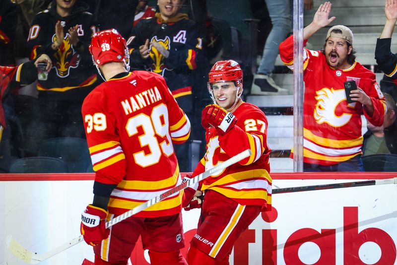 Oct 15, 2024; Calgary, Alberta, CAN; Calgary Flames right wing Matt Coronato (27) celebrates his goal with right wing Anthony Mantha (39) during the third period against the Chicago Blackhawks at Scotiabank Saddledome. Mandatory Credit: Sergei Belski-Imagn Images