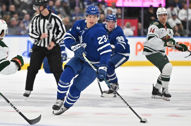 Oct 14, 2023; Toronto, Ontario, CAN;   Toronto Maple Leafs forward Matthew Knies (23) skates with the puck against the Minnesota Wild in the first period at Scotiabank Arena. Mandatory Credit: Dan Hamilton-USA TODAY Sports