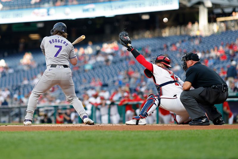 Aug 20, 2024; Washington, District of Columbia, USA; Washington Nationals catcher Riley Adams (15) attempts to catch a wild pitch by Nationals pitcher DJ Herz (not pictured) during an at-bat by Colorado Rockies second baseman Brendan Rodgers (7) during the first inning at Nationals Park. Mandatory Credit: Geoff Burke-USA TODAY Sports