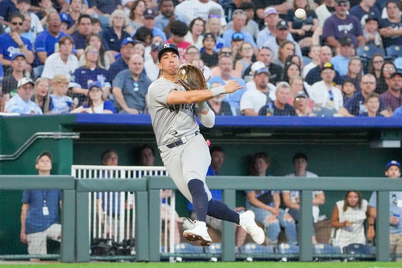Jun 10, 2024; Kansas City, Missouri, USA; New York Yankees third base Oswaldo Cabrera (95) fields a ground ball and throws to first for an out against the Kansas City Royals in the fifth inning at Kauffman Stadium. Mandatory Credit: Denny Medley-USA TODAY Sports