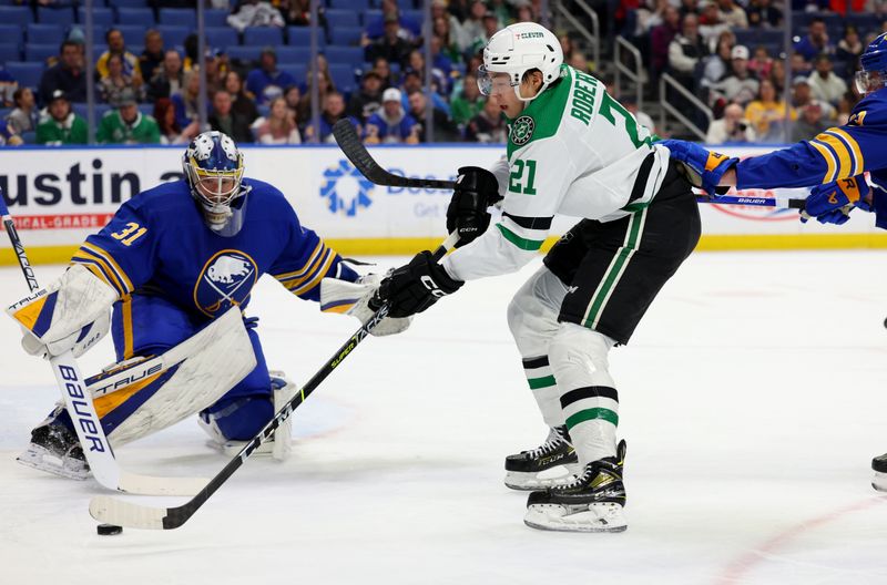 Mar 9, 2023; Buffalo, New York, USA;  Dallas Stars left wing Jason Robertson (21) looks to take a shot on Buffalo Sabres goaltender Eric Comrie (31) during the first period at KeyBank Center. Mandatory Credit: Timothy T. Ludwig-USA TODAY Sports