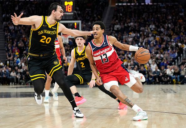 SAN FRANCISCO, CALIFORNIA - DECEMBER 22: Jordan Poole #13 of the Washington Wizards drives on Dario Saric #20 of the Golden State Warriors during the second half at Chase Center on December 22, 2023 in San Francisco, California. NOTE TO USER: User expressly acknowledges and agrees that, by downloading and or using this photograph, User is consenting to the terms and conditions of the Getty Images License Agreement. (Photo by Thearon W. Henderson/Getty Images)