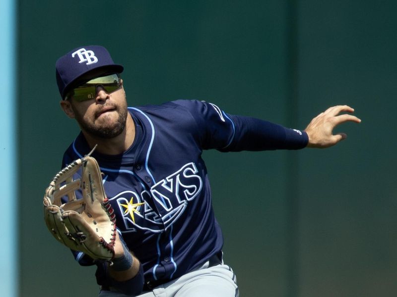 Aug 22, 2024; Oakland, California, USA; Tampa Bay Rays left fielder Dylan Carlson (10) makes a catch on Oakland Athletics shortstop Max Schuemann (not pictured) during the seventh inning at Oakland-Alameda County Coliseum. Mandatory Credit: D. Ross Cameron-USA TODAY Sports