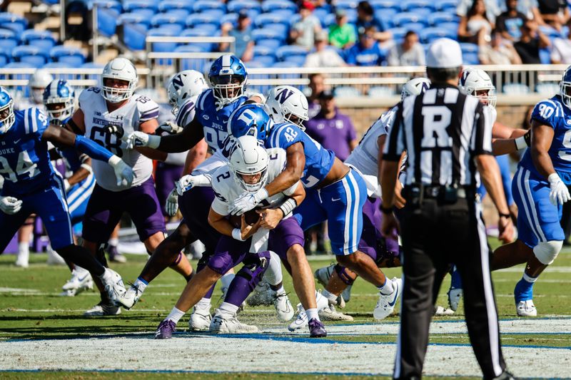Sep 16, 2023; Durham, North Carolina, USA; Duke Blue Devils running back Grissim Anderson (42) tackles Northwestern Wildcats quarterback Ben Bryant (2) during the first half against Duke Blue Devils at Wallace Wade Stadium. Mandatory Credit: Jaylynn Nash-USA TODAY Sports
