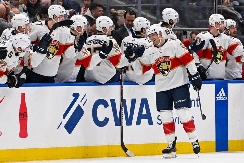 Jan 27, 2024; Elmont, New York, USA; Florida Panthers center Sam Reinhart (13) celebrates his goal against the New York Islanders with the Florida Panthers bench during the second period at UBS Arena. Mandatory Credit: Dennis Schneidler-USA TODAY Sports