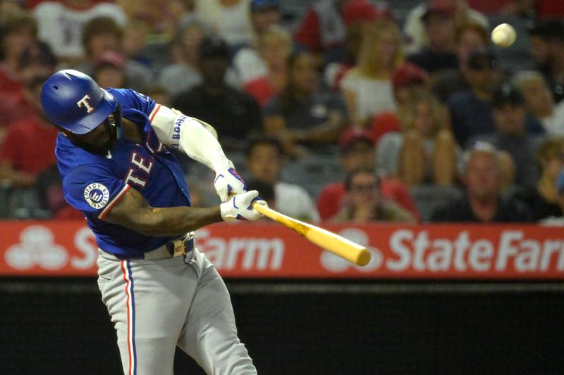 Jul 9, 2024; Anaheim, California, USA;  Texas Rangers left fielder Adolis Garcis (53) hits a solo home run in the eighth inning against the Los Angeles Angels at Angel Stadium. Mandatory Credit: Jayne Kamin-Oncea-USA TODAY Sports