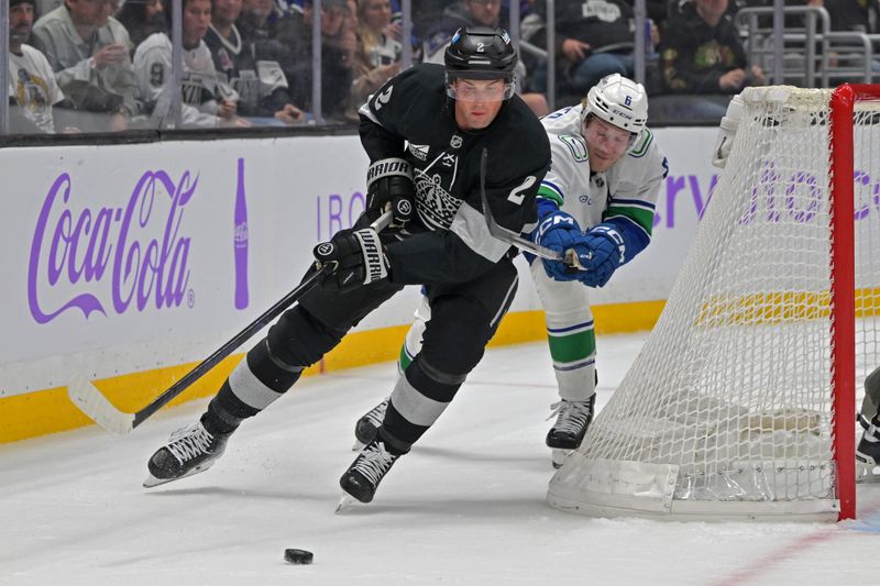 Nov 29, 2025; Los Angeles, California, USA; Los Angeles Kings defenseman Brian Dumoulin (2) is chased down by Vancouver Canucks right wing Brock Boeser (6) during the third period at Crypto.com Arena. Mandatory Credit: Jayne Kamin-Oncea-Imagn Images