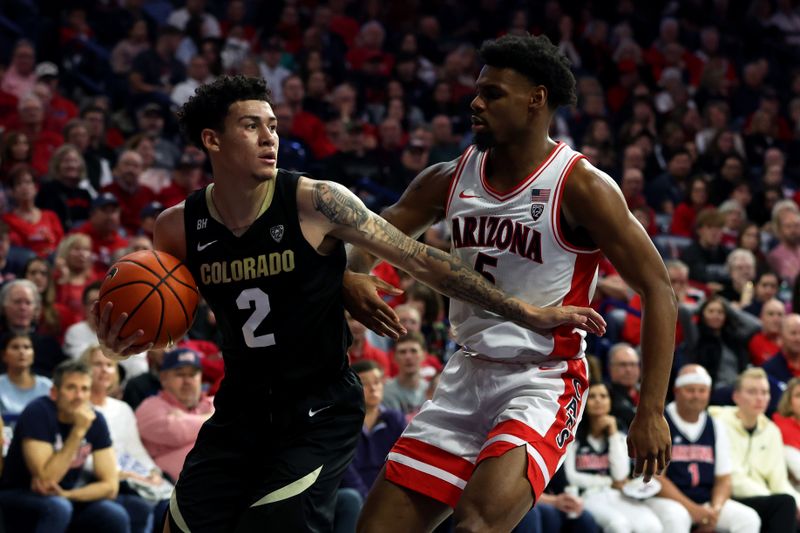 Jan 4, 2024; Tucson, Arizona, USA; Colorado Buffaloes guard KJ Simpson (2) gets a rebound against Arizona Wildcats guard KJ Lewis (5) during the second half at McKale Center. Mandatory Credit: Zachary BonDurant-USA TODAY Sports