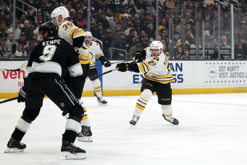 Nov 21, 2025; Los Angeles, California, USA;  Boston Bruins center Alex Steeves (21) shoots the puck during the first period against the Los Angeles Kings at Crypto.com Arena. Mandatory Credit: Kiyoshi Mio-Imagn Images