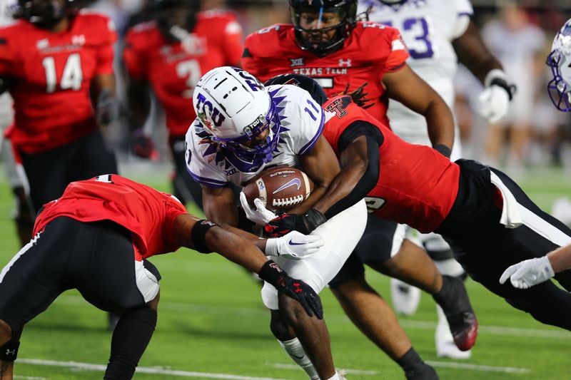 Nov 2, 2023; Lubbock, Texas, USA; Texas Christian Horned Frogs wide receiver JoJo Earle (11) rushes against Texas Tech Red Raiders defensive safety Tyler Owens (18) in the first half at Jones AT&T Stadium and Cody Campbell Field. Mandatory Credit: Michael C. Johnson-USA TODAY Sports