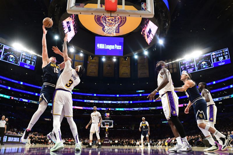 LOS ANGELES, CA - APRIL 27: Nikola Jokic #15 of the Denver Nuggets drives to the basket during the game against the Los Angeles Lakers during Round 1 Game 4 of the 2024 NBA Playoffs on April 27, 2024 at Crypto.Com Arena in Los Angeles, California. NOTE TO USER: User expressly acknowledges and agrees that, by downloading and/or using this Photograph, user is consenting to the terms and conditions of the Getty Images License Agreement. Mandatory Copyright Notice: Copyright 2024 NBAE (Photo by Adam Pantozzi/NBAE via Getty Images)