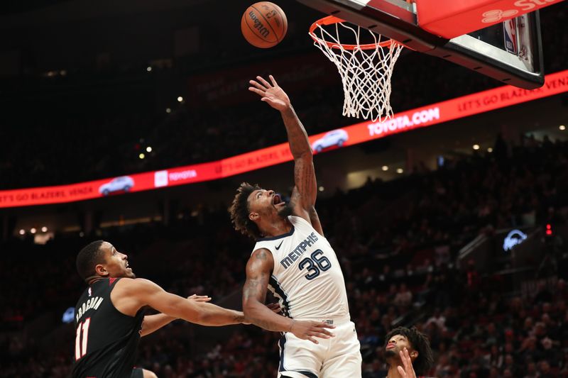 PORTLAND, OREGON - NOVEMBER 03: Marcus Smart #36 of the Memphis Grizzlies hits at a rebound as Malcolm Brogdon #11 of the Portland Trail Blazers defends during the second quarter of an NBA In-Season Tournament game at Moda Center on November 03, 2023 in Portland, Oregon. NOTE TO USER: User expressly acknowledges and agrees that, by downloading and or using this photograph, User is consenting to the terms and conditions of the Getty Images License Agreement.? (Photo by Amanda Loman/Getty Images)