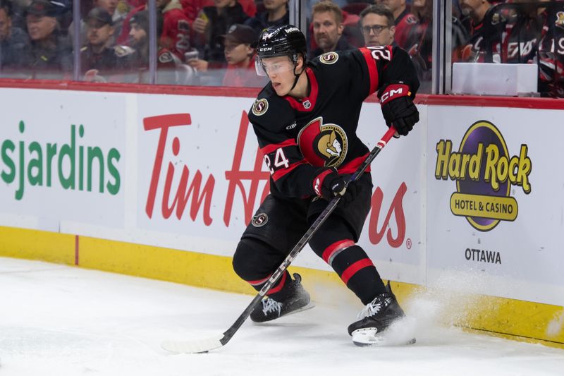 Dec 5, 2024; Ottawa, Ontario, CAN; Ottawa Senators defenseman Jacob Bernard-Docker (24) controls the puck in the second period against the Detroit Red Wings at the Canadian Tire Centre. Mandatory Credit: Marc DesRosiers-Imagn Images