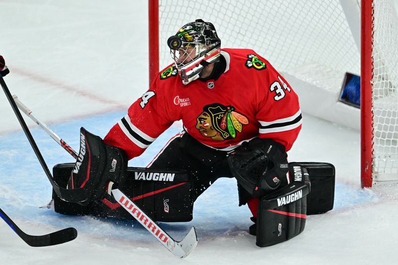 Nov 21, 2024; Chicago, Illinois, USA; Chicago Blackhawks goaltender Petr Mrazek (34) makes a save against the Florida Panthers during the third period at the United Center. Mandatory Credit: Daniel Bartel-Imagn Images