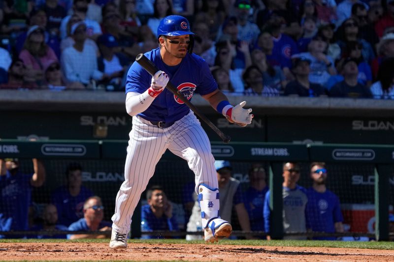 Mar 1, 2024; Mesa, Arizona, USA; Chicago Cubs right fielder Seiya Suzuki (27) hits against the Chicago White Sox during the third inning at Sloan Park. Mandatory Credit: Rick Scuteri-USA TODAY Sports