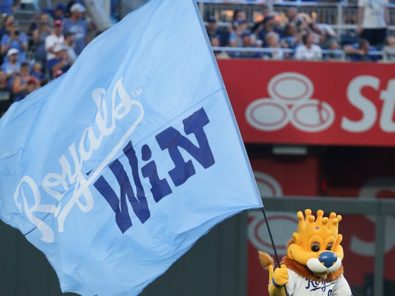 Jul 20, 2024; Kansas City, Missouri, USA; Kansas City Royals mascot Slugger carries a “Royals Win” banner to the field after a Royals victory over the Chicago White Sox at Kauffman Stadium. Mandatory Credit: Scott Sewell-USA TODAY Sports