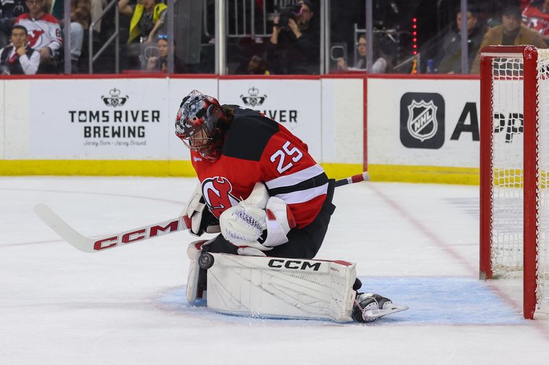 Nov 7, 2024; Newark, New Jersey, USA; New Jersey Devils goaltender Jacob Markstrom (25) makes a save against the Montreal Canadiens during the first period at Prudential Center. Mandatory Credit: Ed Mulholland-Imagn Images