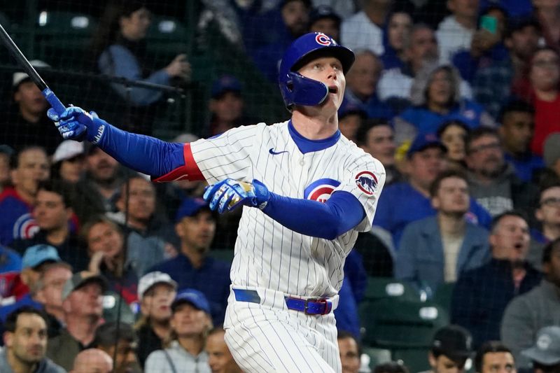May 28, 2025; Chicago, Illinois, USA; Chicago Cubs outfielder Pete Crow-Armstrong (4) hits a home run against the Colorado Rockies during the fourth inning at Wrigley Field. Mandatory Credit: David Banks-Imagn Images