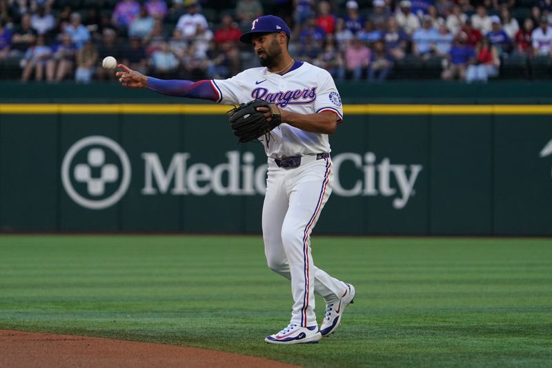 May 3, 2025; Arlington, Texas, USA; Texas Rangers second baseman Marcus Semien (2) throws to first base during the first inning against the Seattle Mariners at Globe Life Field. Mandatory Credit: Raymond Carlin III-Imagn Images