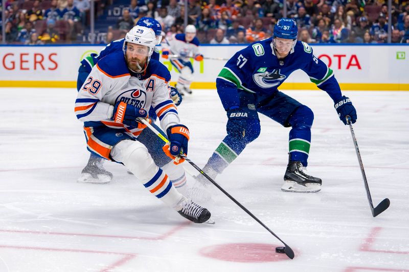 May 20, 2024; Vancouver, British Columbia, CAN; Vancouver Canucks defenseman Tyler Myers (57) Edmonton Oilers forward Leon Draisaitl (29) handle the puck during the second period in game seven of the second round of the 2024 Stanley Cup Playoffs at Rogers Arena. Mandatory Credit: Bob Frid-USA TODAY Sports