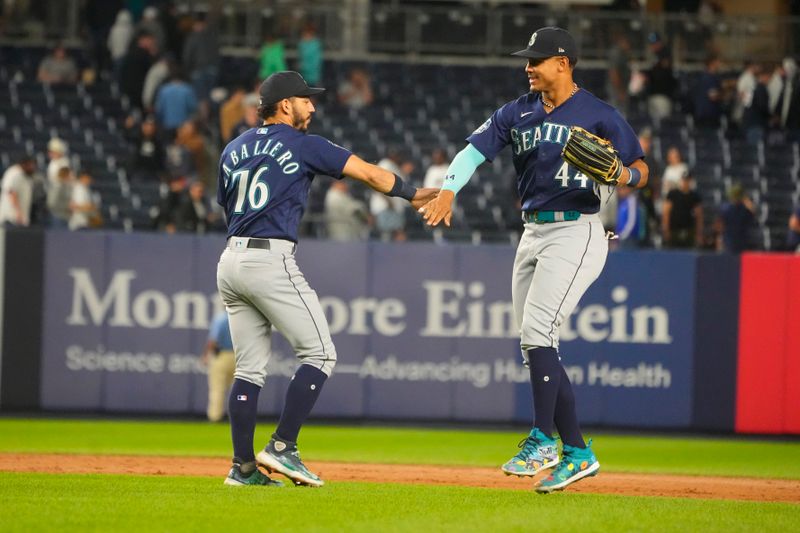 Jun 22, 2023; Bronx, New York, USA;  Seattle Mariners second baseman Jose Caballero (76) and center fielder Julio Rodriguez (44) celebrate the victory against the New York Yankees at Yankee Stadium. Mandatory Credit: Gregory Fisher-USA TODAY Sports