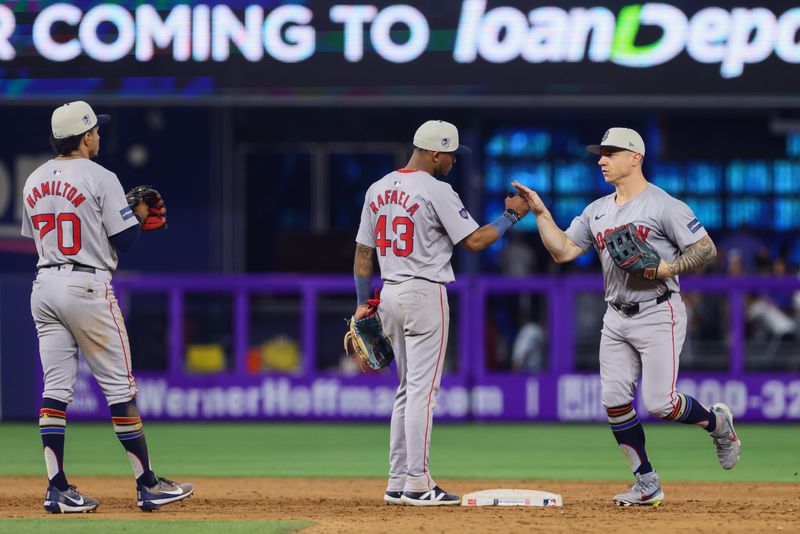 Jul 4, 2024; Miami, Florida, USA; Boston Red Sox left fielder Tyler O'Neill (17) celebrates with shortstop Ceddanne Rafaela (43) after the game against the Miami Marlins at loanDepot Park. Mandatory Credit: Sam Navarro-USA TODAY Sports