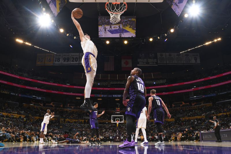 LOS ANGELES, CA - OCTOBER 26:  Austin Reaves #15 of the Los Angeles Lakers drives to the basket during the game against the Sacramento Kings on October 26, 2024 at Crypto.Com Arena in Los Angeles, California. NOTE TO USER: User expressly acknowledges and agrees that, by downloading and/or using this Photograph, user is consenting to the terms and conditions of the Getty Images License Agreement. Mandatory Copyright Notice: Copyright 2024 NBAE (Photo by Adam Pantozzi/NBAE via Getty Images)