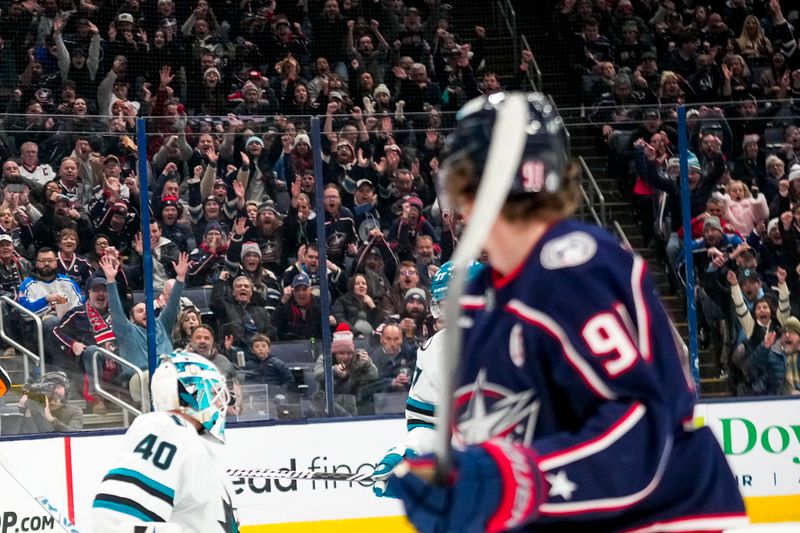 Jan 16, 2025; Columbus, Ohio, USA; Columbus Blue Jackets center Kent Johnson (91) looks back after scoring a goal against San Jose Sharks goaltender Alexandar Georgiev (40) in the first period at Nationwide Arena on Thursday, Jan. 16, 2025 in Columbus, Ohio.   Mandatory Credit: Samantha Madar/USA TODAY Network via Imagn Images 