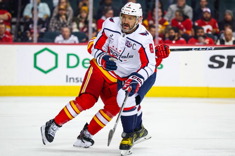 Jan 28, 2025; Calgary, Alberta, CAN; Washington Capitals left wing Alex Ovechkin (8) and Calgary Flames center Mikael Backlund (11) fights for position during the first period at Scotiabank Saddledome. Mandatory Credit: Sergei Belski-Imagn Images