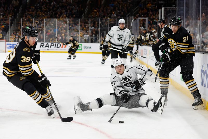 Feb 17, 2024; Boston, Massachusetts, USA; Los Angeles Kings right wing Alex Laferriere (78) goes down trying to play the puck between Boston Bruins left wing James van Riemsdyk (21) and center Morgan Geekie (39) during the first period at TD Garden. Mandatory Credit: Winslow Townson-USA TODAY Sports