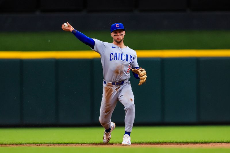 May 25, 2025; Cincinnati, Ohio, USA; Chicago Cubs second baseman Nico Hoerner (2) throws to first to get Cincinnati Reds outfielder Will Benson (not pictured) out in the eighth inning at Great American Ball Park. Mandatory Credit: Katie Stratman-Imagn Images