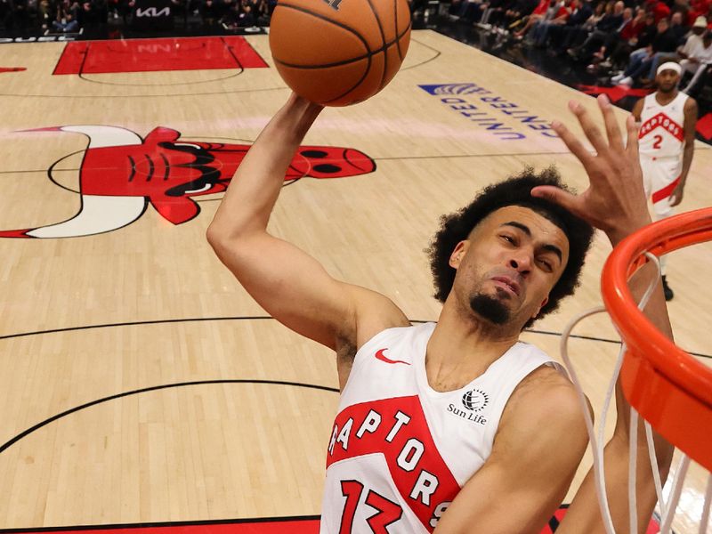 CHICAGO, ILLINOIS - JANUARY 30: Jordan Nwora #13 of the Toronto Raptors attempts a dunk over Dalen Terry #25 of the Chicago Bulls at the United Center on January 30, 2024 in Chicago, Illinois. NOTE TO USER: User expressly acknowledges and agrees that, by downloading and or using this photograph, User is consenting to the terms and conditions of the Getty Images License Agreement.  (Photo by Michael Reaves/Getty Images)