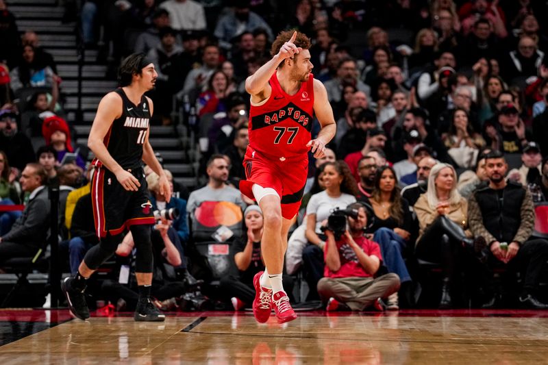 TORONTO, ON - DECEMBER 1: Jamison Battle #77 of the Toronto Raptors celebrates after making a three point shot against the Miami Heat at Scotiabank Arena on December 1, 2024 in Toronto, Ontario, Canada. NOTE TO USER: User expressly acknowledges and agrees that, by downloading and/or using this Photograph, user is consenting to the terms and conditions of the Getty Images License Agreement. (Photo by Andrew Lahodynskyj/Getty Images)