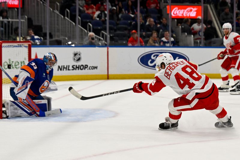 Oct 23, 2025; Elmont, New York, USA;  Detroit Red Wings right wing Jonatan Berggren (48) scores a goal past New York Islanders goaltender David Rittich (33) during the third period at UBS Arena. Mandatory Credit: Dennis Schneidler-Imagn Images