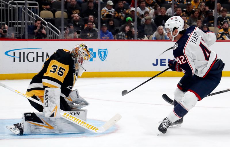 Mar 5, 2024; Pittsburgh, Pennsylvania, USA; Pittsburgh Penguins goaltender Tristan Jarry (35) makes a save against Columbus Blue Jackets center Alexandre Texier (42) during the second period at PPG Paints Arena. Mandatory Credit: Charles LeClaire-USA TODAY Sports